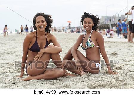 Mixed race friends sitting on beach View Large Photo Image Stock Photo - Mixed race friends sitting on beach. Fotosearch