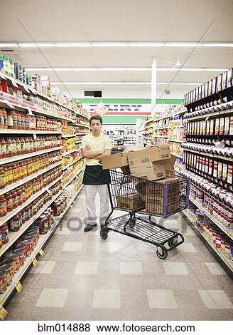 Mixed race man working in grocery store View Large Photo Image Stock Photo - Mixed race man working in grocery store. Fotosearch