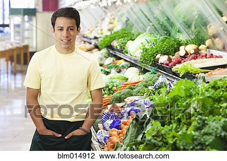 Mixed race worker in produce section of grocery store View Large Photo Image Stock Image - Mixed race worker in produce section of grocery store. Fotosearch