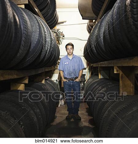 Mixed race worker in tire store View Large Photo Image Stock Image - Mixed race worker in tire store. Fotosearch