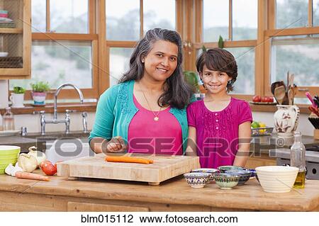 Mother and daughter cooking in kitchen View Large Photo Image Stock Image - Mother and daughter cooking in kitchen. Fotosearch