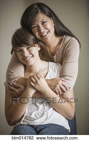 Mother and daughter hugging View Large Photo Image Stock Image - Mother and daughter hugging. Fotosearch