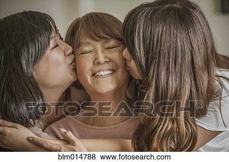 Mother and daughter kissing grandmother View Large Photo Image Stock Photo - Mother and daughter kissing grandmother. Fotosearch