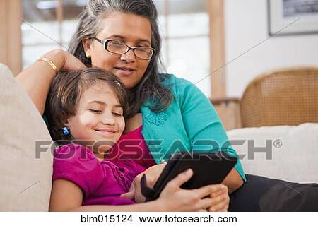 Picture - Mother and daughter using digital tablet. Fotosearch