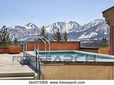 Stock Photo - Mountains behind hot tub. Fotosearch
