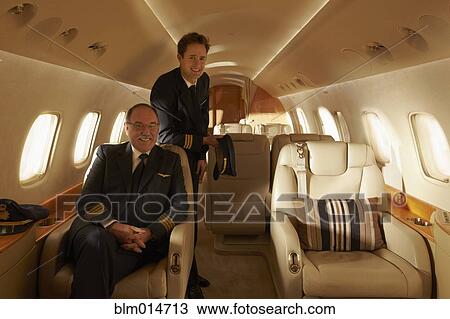 Stock Image - Pilots on private jet. Fotosearch