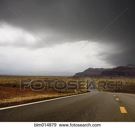 Remote highway and cliff with storm above View Large Photo Image Stock Photo - Remote highway and cliff with storm above. Fotosearch