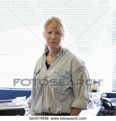 Serious Caucasian woman in office View Large Photo Image Stock Photo - Serious Caucasian woman in office. Fotosearch