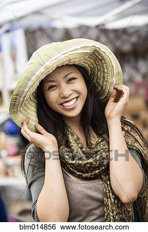 Smiling Chinese woman in hat View Large Photo Image Stock Photograph - Smiling Chinese woman in hat. Fotosearch