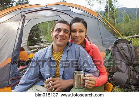Stock Photo - Smiling couple camping together. Fotosearch