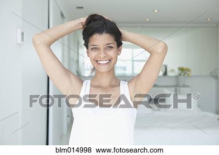 Smiling Hispanic woman with arms raised View Large Photo Image Stock Photo - Smiling Hispanic woman with arms raised. Fotosearch