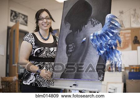 Stock Photo - Woman displaying artwork. Fotosearch