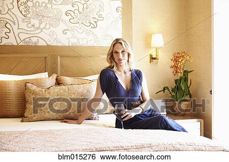 Woman drinking wine in elegant bedroom View Large Photo Image Stock Photograph - Woman drinking wine in elegant bedroom. Fotosearch