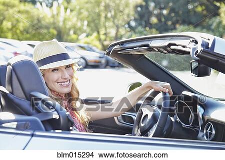 Picture - Woman driving convertible. Fotosearch