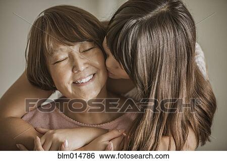 Stock Photograph - Woman kissing grandmother. Fotosearch