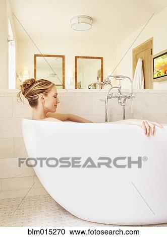 Woman soaking in bathtub View Large Photo Image Stock Image - Woman soaking in bathtub. Fotosearch