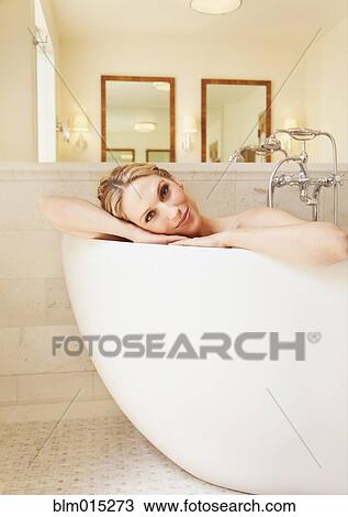 Stock Image - Woman soaking in bathtub. Fotosearch