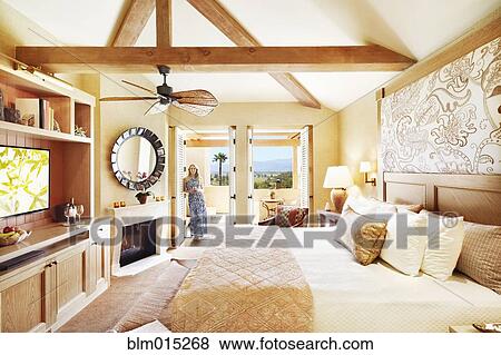 Woman standing in elegant bedroom View Large Photo Image Stock Photo - Woman standing in elegant bedroom. Fotosearch