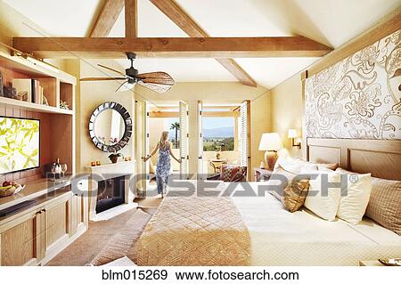 Woman standing in elegant bedroom View Large Photo Image Stock Photo - Woman standing in elegant bedroom. Fotosearch