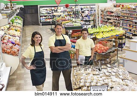 Workers in produce section of grocery store View Large Photo Image Stock Image - Workers in produce section of grocery store. Fotosearch