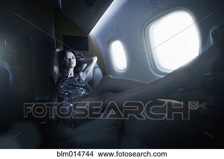 Picture - Young woman flying on private jet. Fotosearch