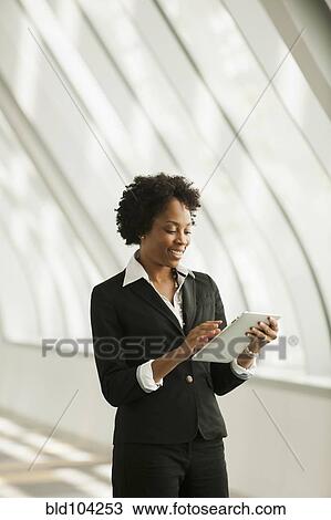 Stock Image - African American businesswoman using digital tablet. Fotosearch