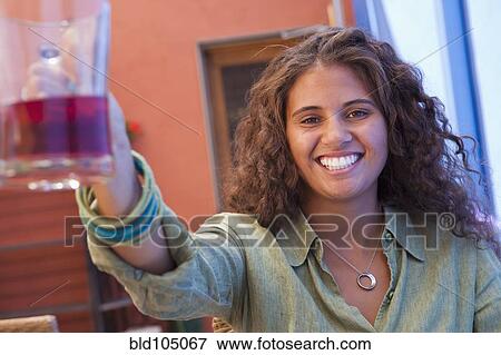 Stock Photo - African American woman drinking wine. Fotosearch