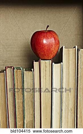 Apple on top of books View Large Photo Image Stock Photography - Apple on top of books. Fotosearch