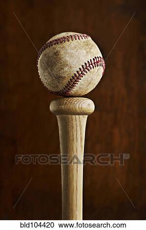 Stock Image - Baseball balancing on baseball bat. Fotosearch