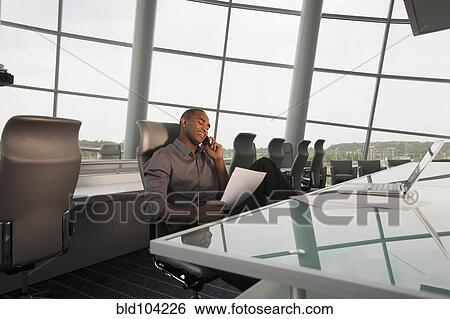 Stock Photograph - Black businessman working in conference room. Fotosearch