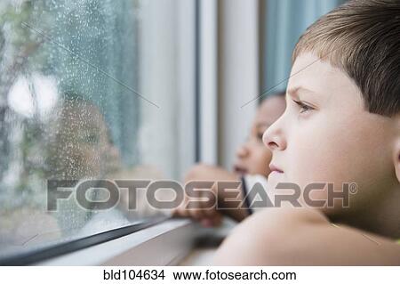 Picture - Boys looking out window together. Fotosearch