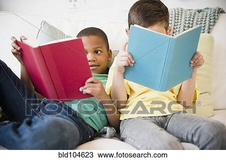 Stock Image - Boys reading books together. Fotosearch