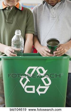 Stock Photo - Boys recycling together. Fotosearch