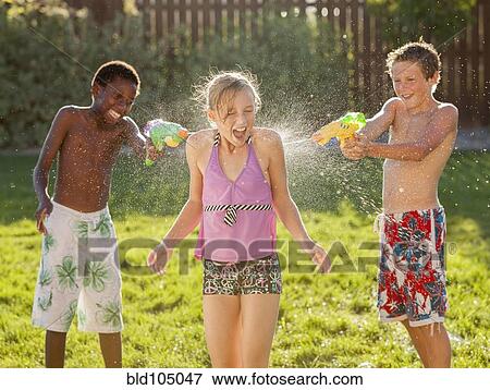 Boys squirting girl with water guns View Large Photo Image Stock Photo - Boys squirting girl with water guns. Fotosearch