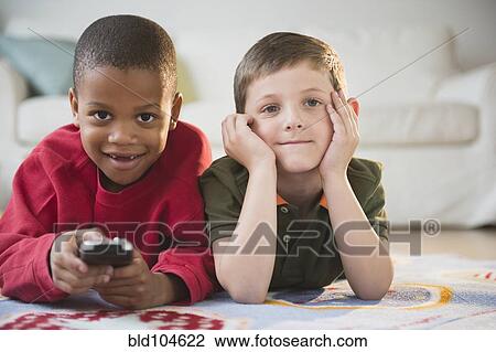 Stock Image - Boys watching television together. Fotosearch