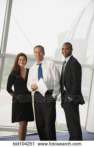 Stock Image - Business people standing together. Fotosearch