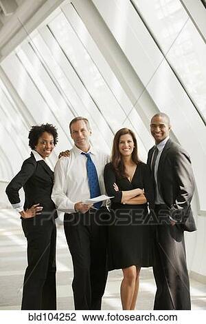 Stock Image - Business people standing together. Fotosearch