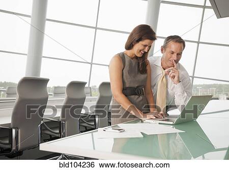 Business people working in conference room View Large Photo Image Stock Photograph - Business people working in conference room. Fotosearch