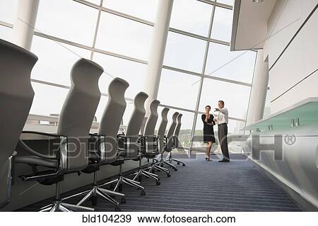 Business people working together in conference room View Large Photo Image Stock Photo - Business people working together in conference room. Fotosearch