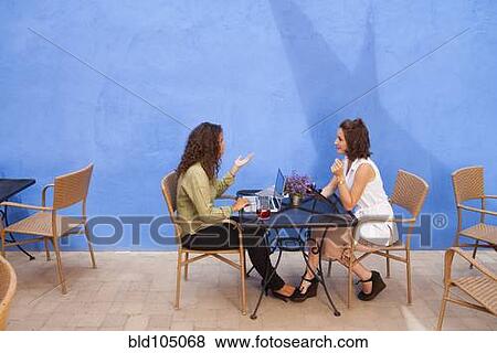 Businesswomen having meeting in outdoor cafe View Large Photo Image Stock Photo - Businesswomen having meeting in outdoor cafe. Fotosearch