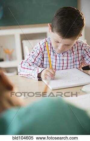 Caucasian boy writing in notebook View Large Photo Image Stock Photography - Caucasian boy writing in notebook. Fotosearch