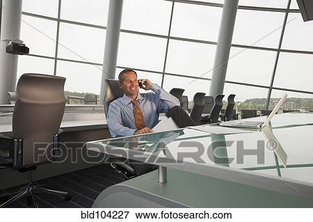 Stock Photo - Caucasian businessman working in conference room. Fotosearch
