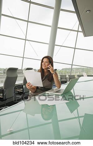 Picture - Caucasian businesswoman working in conference room. Fotosearch
