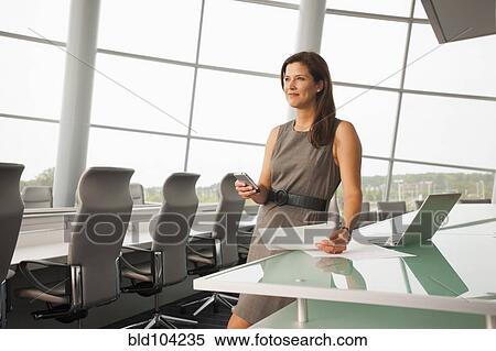 Stock Photography - Caucasian businesswoman working in conference room. Fotosearch