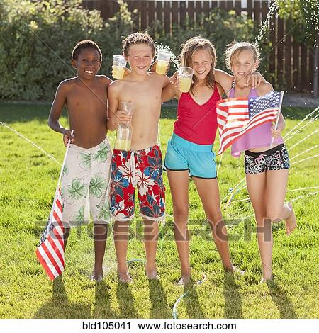 Stock Image - Caucasian friends drinking lemonade on Fourth of July. Fotosearch