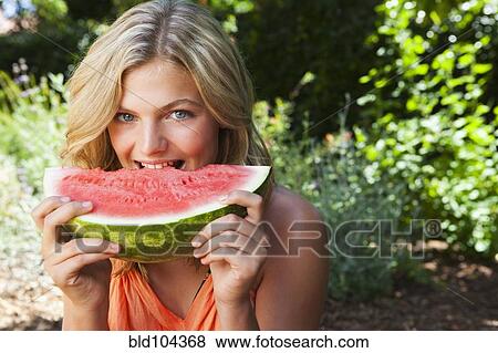 Stock Photo - Caucasian girl eating watermelon. Fotosearch