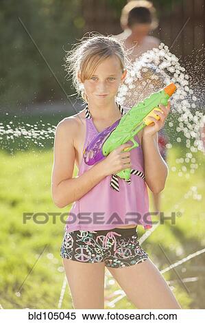 Stock Photography - Caucasian girl holding a water gun. Fotosearch