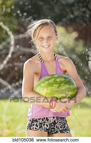 Stock Photo - Caucasian girl holding watermelon. Fotosearch