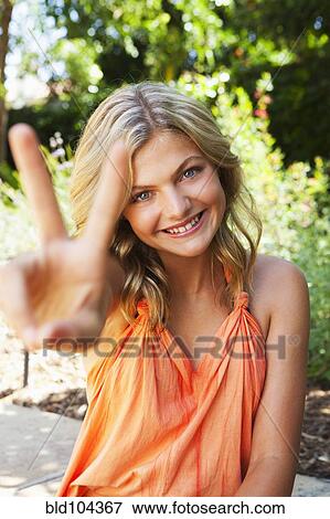 Stock Photo - Caucasian girl making the peace sign. Fotosearch