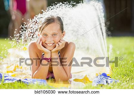 Caucasian girl playing in water View Large Photo Image Stock Image - Caucasian girl playing in water. Fotosearch